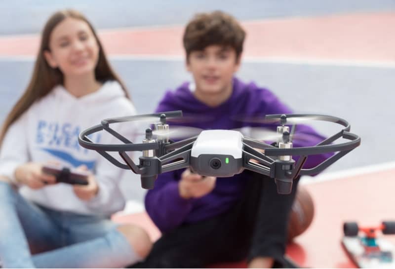 Boy and girl flying a DJI Tello drone